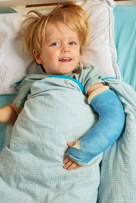 Framed Print : Blond boy in hospital bed with plaster cast on the broken hand Framed Print : Blond boy in hospital bed with plaster cast on the broken hand
