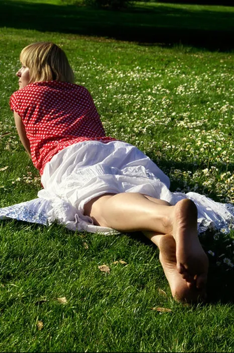 Framed Print : Blonde bare feet young woman teen girl lying down on lawn grass wearing red blouse and white long skirt back Framed Print : Blonde bare feet young woman teen girl lying down on lawn grass wearing red blouse and white long skirt back
