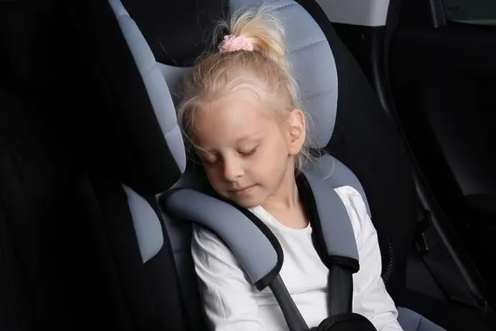 Framed Print : Blonde girl sleeping in child safety seat Framed Print : Blonde girl sleeping in child safety seat