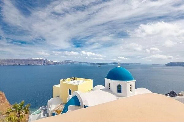 Blue dome in Santorini, Fira. Summer vacation landscape, peaceful sea view and volcanic cliff. Caldera view, cloudy sky