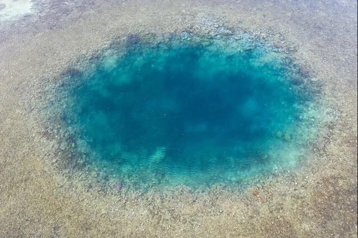 Framed Print : Blue holes are found amid a shallow reef flat on the island of Sebayor in Komodo National Park, Indonesia. These blue holes formed as sink holes Framed Print : Blue holes are found amid a shallow reef flat on the island of Sebayor in Komodo National Park, Indonesia. These blue holes formed as sink holes