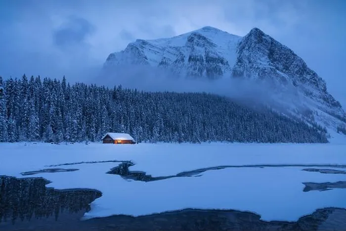 Framed Print : Blue Hour sets in at Lake Louise in mid-January as snow clouds swirl in around Mount Fairview in Banff National Park Framed Print : Blue Hour sets in at Lake Louise in mid-January as snow clouds swirl in around Mount Fairview in Banff National Park