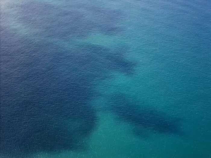 Framed Print : Blue ocean water with dark spot aerial drone view Framed Print : Blue ocean water with dark spot aerial drone view