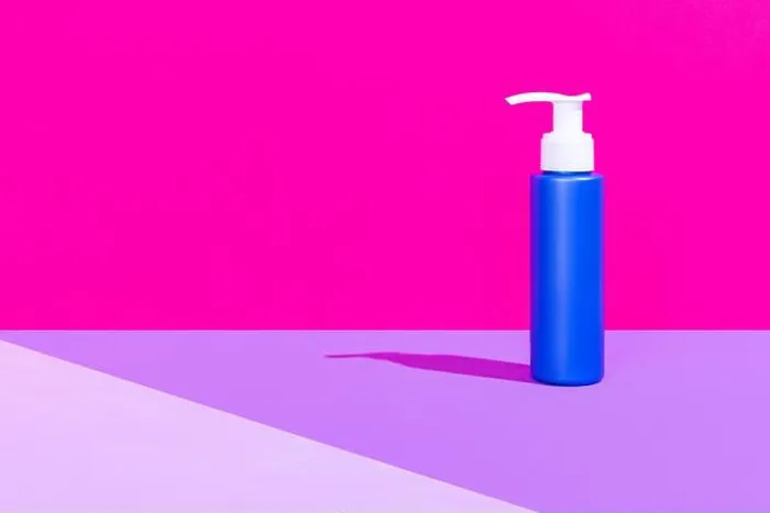 Framed Print : One blue pump bottle for cosmetics product, cream, lotion without logos standing isolated over magenta pink background Framed Print : One blue pump bottle for cosmetics product, cream, lotion without logos standing isolated over magenta pink background
