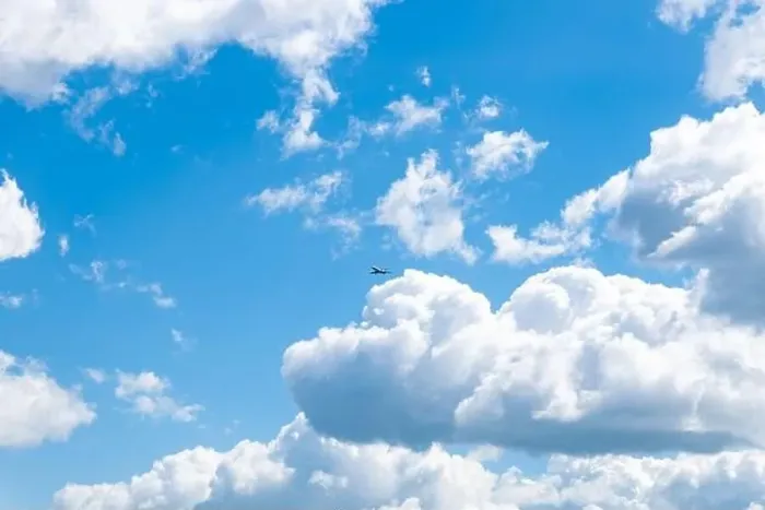 Framed Print : in a blue sky with beautiful clouds flies an airplane Framed Print : in a blue sky with beautiful clouds flies an airplane