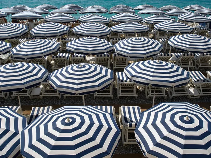 Framed Print : Blue and white beach umbrellas by the sea on the French Riviera Framed Print : Blue and white beach umbrellas by the sea on the French Riviera