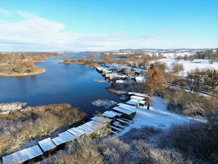 Framed Print : Boathouses at Lake Teterow in white winter Framed Print : Boathouses at Lake Teterow in white winter
