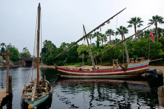 Framed Print : Two boats on the river with sails furled and the dock on the left. Palm trees in the background Framed Print : Two boats on the river with sails furled and the dock on the left. Palm trees in the background