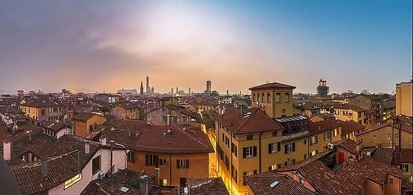 Bologna, Italy rooftop skyline and famous historic towers at dusk