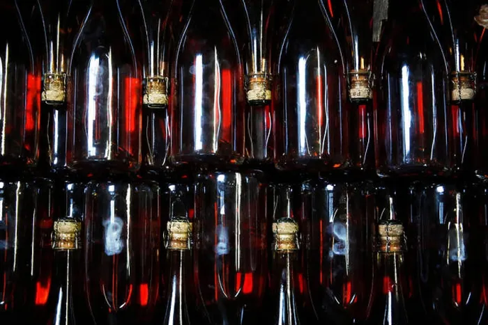 Framed Print : Bottles of sparkling Rose wait to be labeled at the winery of Hambledon Vineyard situated on the South Downs near Framed Print : Bottles of sparkling Rose wait to be labeled at the winery of Hambledon Vineyard situated on the South Downs near