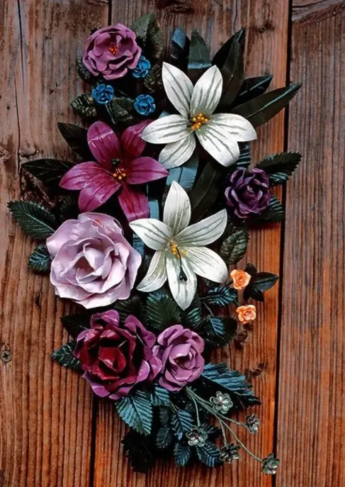 Framed Print : Bouquet of metal flowers attached to a wooden door Framed Print : Bouquet of metal flowers attached to a wooden door