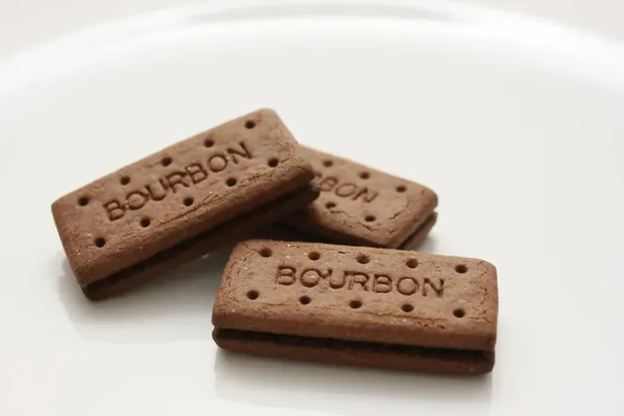 Framed Print : Three Bourbon biscuits arranged on a white plate Framed Print : Three Bourbon biscuits arranged on a white plate