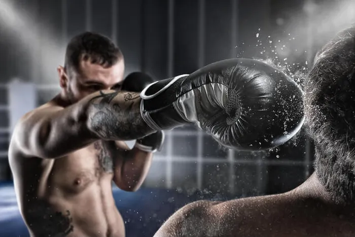 Framed Print : Boxer in a boxe competition beats his opponent Framed Print : Boxer in a boxe competition beats his opponent