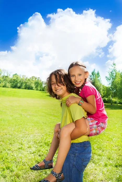Framed Print : boy carry girl on his back, both look happy and smiling, in the park on sunny summer day Framed Print : boy carry girl on his back, both look happy and smiling, in the park on sunny summer day
