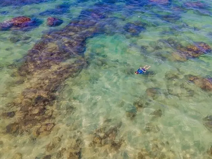 Framed Print : Boy is snorkeling among the corals. View from the drone