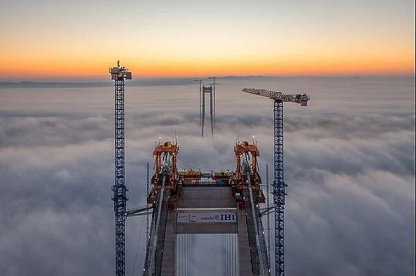 Braila, Romania - November 13, 2022: IHI Webuild japonese company building the bridge over Danube River near Braila City in Romania. Panoramic aerial