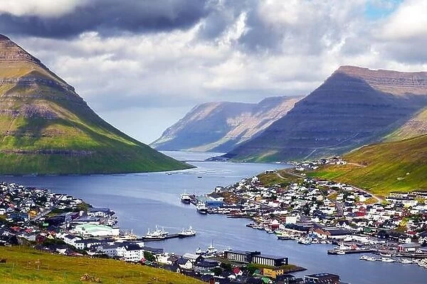 Breathtaking cityscape of Klaksvik town with fjord and cloudy mountains, Bordoy island, Faroe islands, Denmark. Landscape photography
