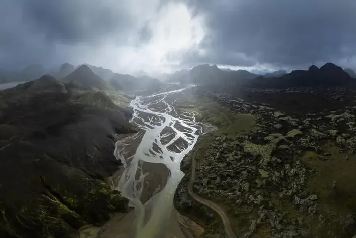 Framed Print : Breathtaking drone view of river estuary in sunlit valley amidst mountains in cloudy morning in Iceland Framed Print : Breathtaking drone view of river estuary in sunlit valley amidst mountains in cloudy morning in Iceland