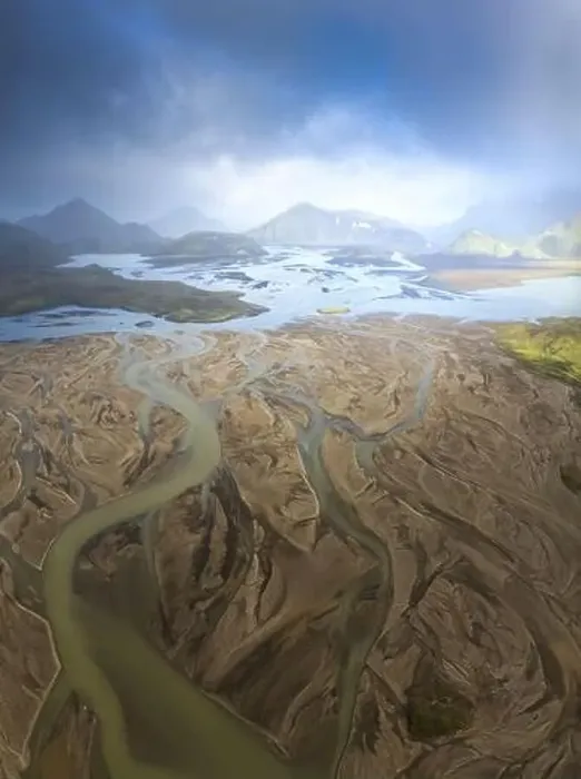 Framed Print : Breathtaking drone view of river estuary in sunlit valley amidst mountains in cloudy morning in Iceland Framed Print : Breathtaking drone view of river estuary in sunlit valley amidst mountains in cloudy morning in Iceland