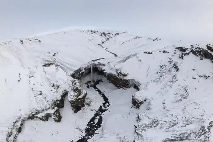 Framed Print : Breathtaking drone view of snowy mountain with waterfall Framed Print : Breathtaking drone view of snowy mountain with waterfall