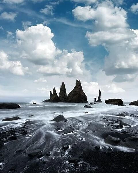 Breathtaking landscape with basalt rock formations Troll Toes on Black beach, stormy ocean waves and cloudscape. Reynisdrangar, Vik, Iceland