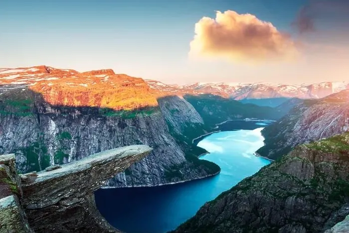 Framed Print : Breathtaking view of Trolltunga rock - most spectacular and famous scenic cliff in Norway. Picturesque landscape with sunset sky and clear lake Framed Print : Breathtaking view of Trolltunga rock - most spectacular and famous scenic cliff in Norway. Picturesque landscape with sunset sky and clear lake