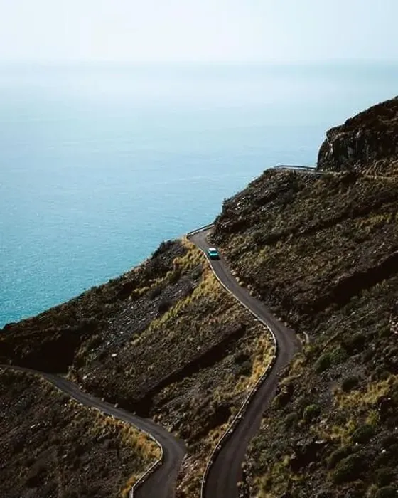 Framed Print : Breathtaking view of vehicle driving on curvy road on slope of mountain against sea during trip in La Palma, Spain Framed Print : Breathtaking view of vehicle driving on curvy road on slope of mountain against sea during trip in La Palma, Spain
