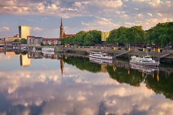 Bremen, Germany. Cityscape image of riverside Bremen, Germany with reflection of the St. Stephani Church in Weser River at summer sunrise
