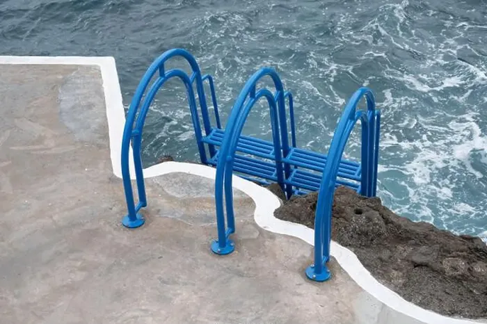Framed Print : Bright blue ladder leads into the churning ocean waters at Porto Moniz natural pools Framed Print : Bright blue ladder leads into the churning ocean waters at Porto Moniz natural pools