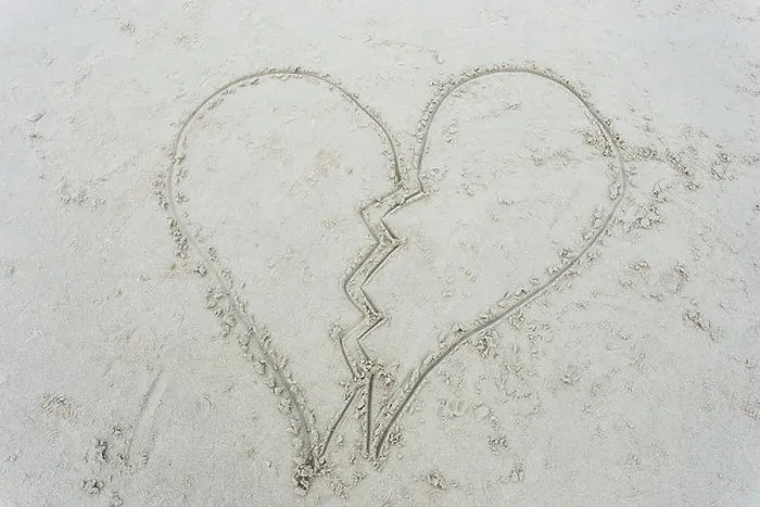 Framed Print : broken heart drawn on sand at beach