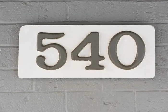 Framed Print : Building number five hundred and forty (540) on a white plaque against a grey brick wall Framed Print : Building number five hundred and forty (540) on a white plaque against a grey brick wall