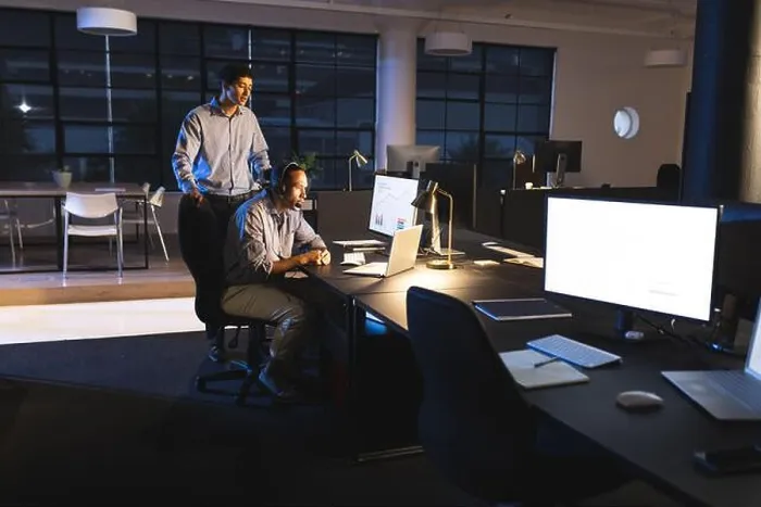 Framed Print : Business diverse professionals collaborating on project in modern office during night Framed Print : Business diverse professionals collaborating on project in modern office during night