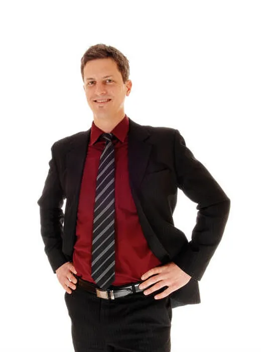 Framed Print : An business man in a suit standing isolated for white background with his hands on his hips and smiling Framed Print : An business man in a suit standing isolated for white background with his hands on his hips and smiling