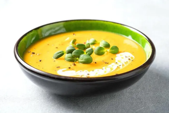 Framed Print : Butternut squash cream soup garnished with heavy cream and fresh sunflower microgreen
