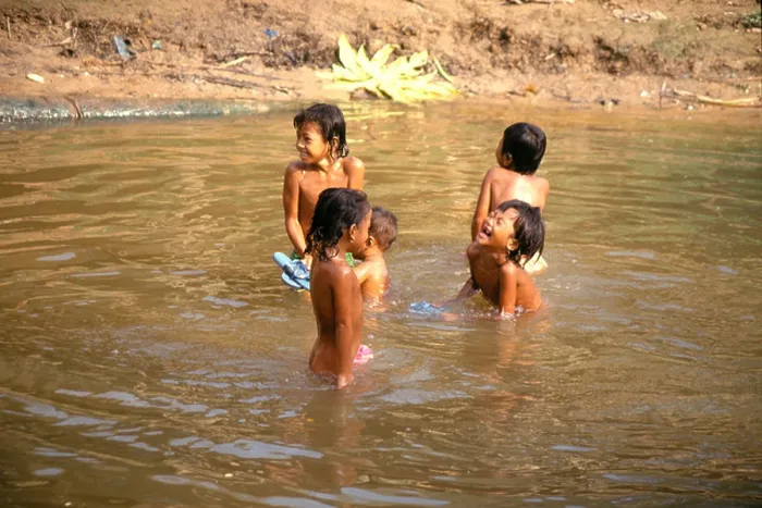 Framed Print : Cambodian children playing in the water at Angkor Wat temple.Siem Reap Framed Print : Cambodian children playing in the water at Angkor Wat temple.Siem Reap