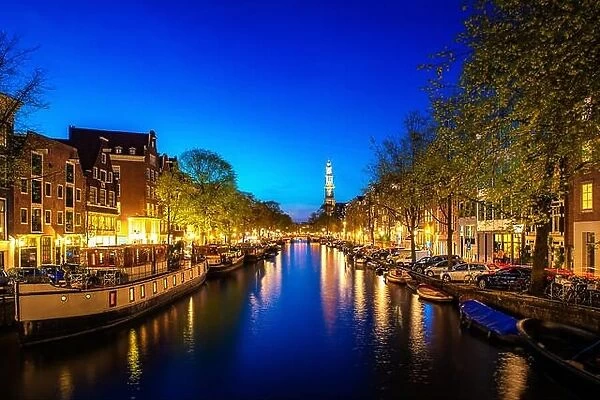 Canals of Amsterdam at night in Netherlands. Amsterdam is the capital and most populous city of the Netherlands
