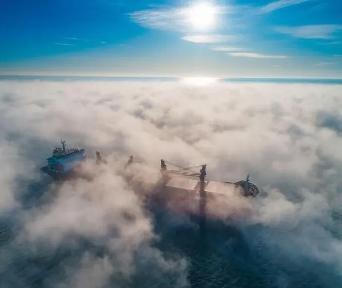 Framed Print : Cargo ship and cranes silhouettes in sea fog, crane vessel working for delivery of delivery containers