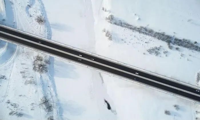 Framed Print : Cars move on bridge road in winter time aerial above drone view Framed Print : Cars move on bridge road in winter time aerial above drone view