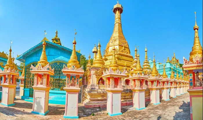 Framed Print : The carved golden pagoda amid the colorful temples and richly decorated shrines of Thanboddhay monastery Framed Print : The carved golden pagoda amid the colorful temples and richly decorated shrines of Thanboddhay monastery