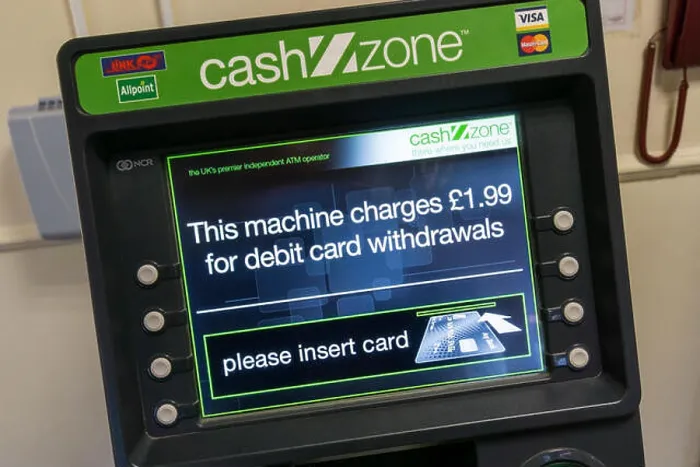 Framed Print : A CashZone ATM in a motorway service station warns that there is a £1.99 charge for cash withdrawals by debit card Framed Print : A CashZone ATM in a motorway service station warns that there is a £1.99 charge for cash withdrawals by debit card