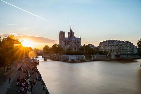Cathedral of Notre Dame de Paris with Seine river at sunset. Paris, France