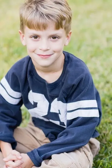 Framed Print : Caucasian boy smiling on lawn Framed Print : Caucasian boy smiling on lawn