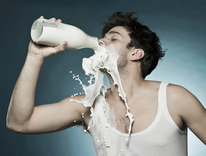Framed Print : Caucasian man drinking milk and spilling it Framed Print : Caucasian man drinking milk and spilling it