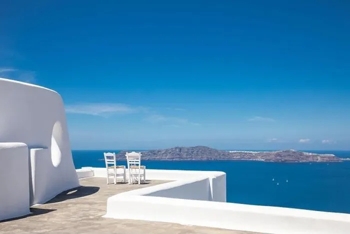Framed Print : Two chairs on the terrace with sea view. White architecture on Santorini island, Greece. Travel destinations concept, summer holiday, luxury landscape Framed Print : Two chairs on the terrace with sea view. White architecture on Santorini island, Greece. Travel destinations concept, summer holiday, luxury landscape
