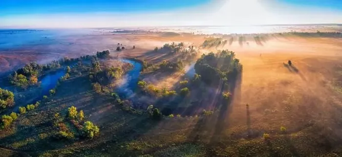 Framed Print : The channel and bends of the river, on a marshy meadow. Orange dry grass, scorched by the summer heat, and morning fog Framed Print : The channel and bends of the river, on a marshy meadow. Orange dry grass, scorched by the summer heat, and morning fog