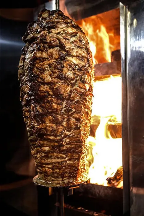 Framed Print : Charcoal shawarma meat. Closeup of chicken meat collected on a vertical skewer and grilled on charcoal Framed Print : Charcoal shawarma meat. Closeup of chicken meat collected on a vertical skewer and grilled on charcoal
