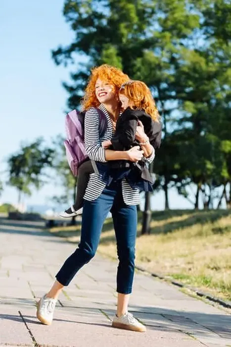 Framed Print : Charming red haired female holding her child Framed Print : Charming red haired female holding her child