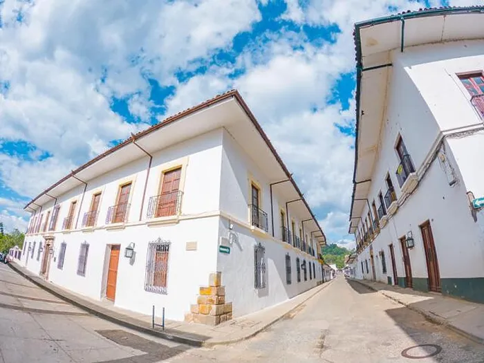 Framed Print : Charming street scene in Popayán, Colombia, featuring traditional white buildings and a clear blue sky Framed Print : Charming street scene in Popayán, Colombia, featuring traditional white buildings and a clear blue sky