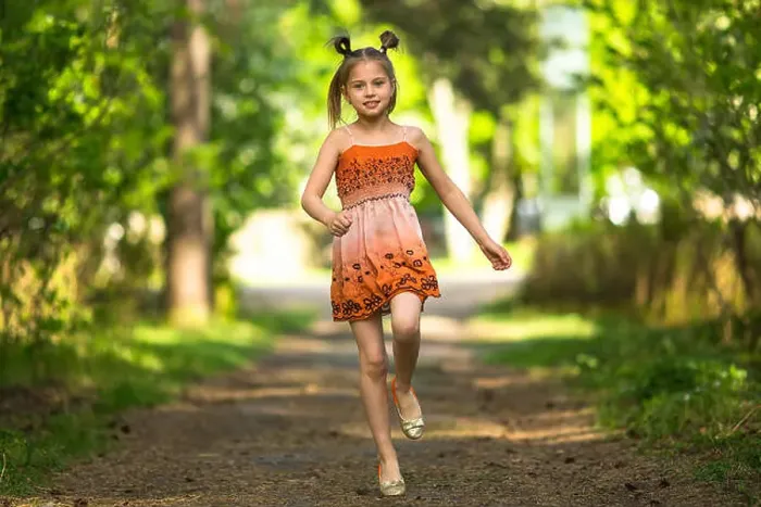 Framed Print : Cheerful little girl running along a path in a park Framed Print : Cheerful little girl running along a path in a park