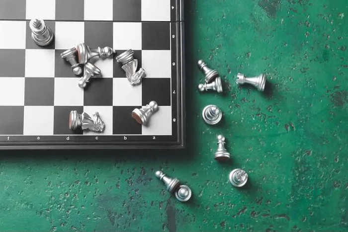 Framed Print : Chess pieces with game board on color background Framed Print : Chess pieces with game board on color background